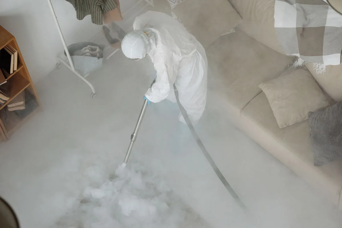 Biohazard cleanup technician in protective equipment, Fremont, MI